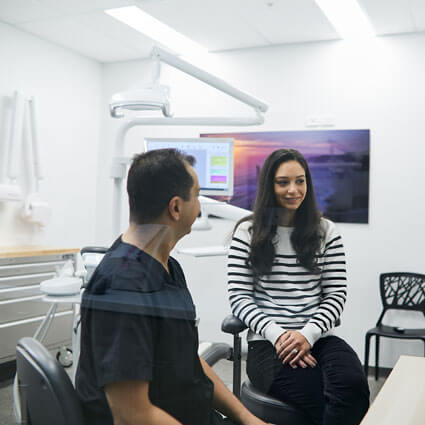 Dr Mina with female patient in treatment room