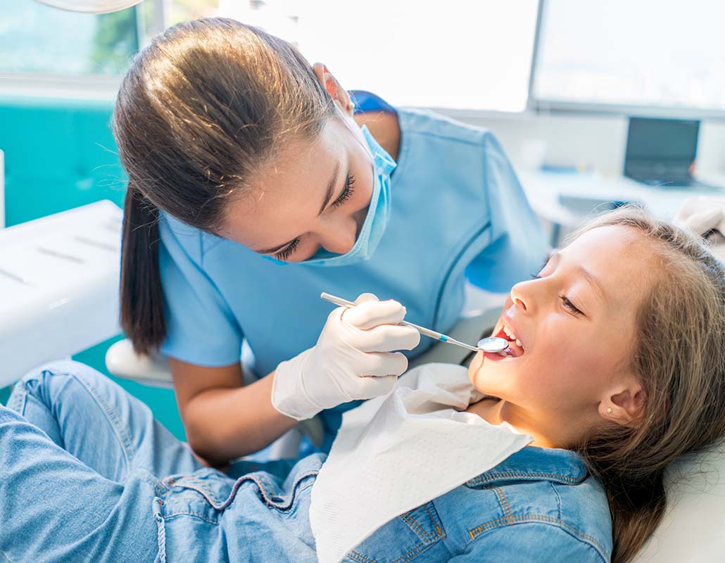 dentist looking in child's mouth