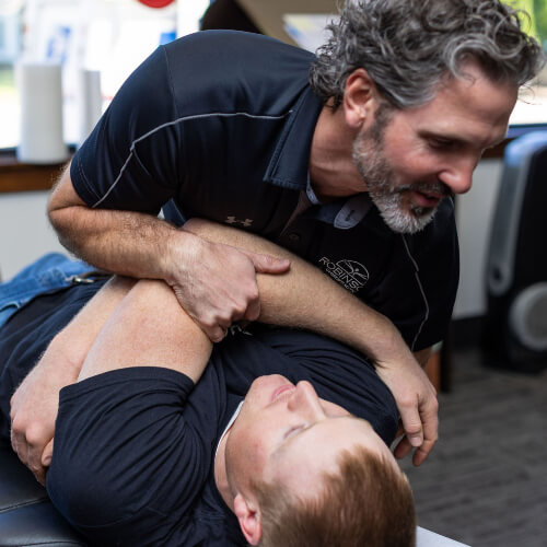 Chiropractor adjusting a male patient