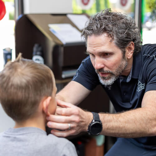 Chiropractor inspecting pediatric patient