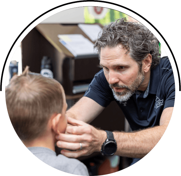 Chiropractor checking kid patient