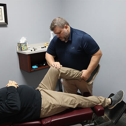 Dr Nathan adjusting patients knee