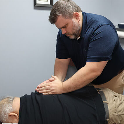 Dr Nathan adjusting patients back