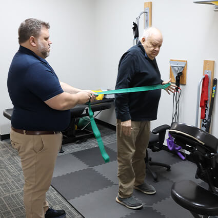 Gahanna chiropractor Dr Nathan using resistance band with patient