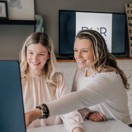 Doctors pointing to computer