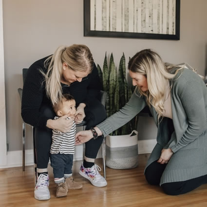 Dr. Kirstie welcoming mom and baby