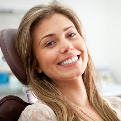 woman smiling in a dentists chair