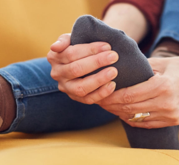 woman massaging foot