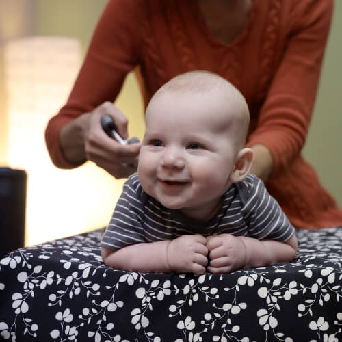 Chiropractor adjusting a baby