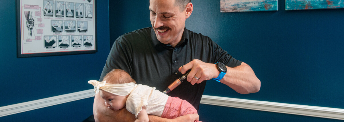 Dr Juan adjusting babys back