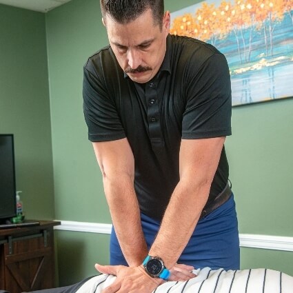 Dr Aaron adjusting patients back