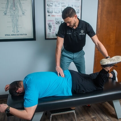 Dr Juan adjusting patients back
