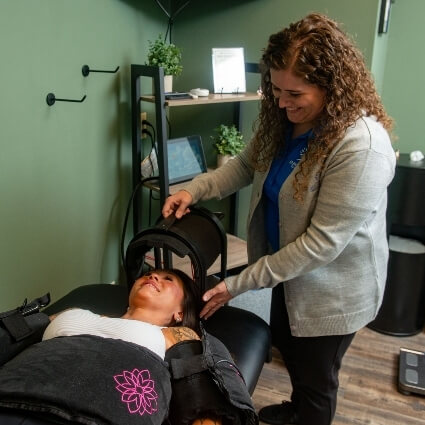 patient getting red light therapy tool put on their head
