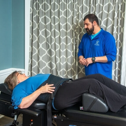 patient sitting in spinal decompression chair