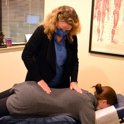 chiropractor adjusting a patient's lower back
