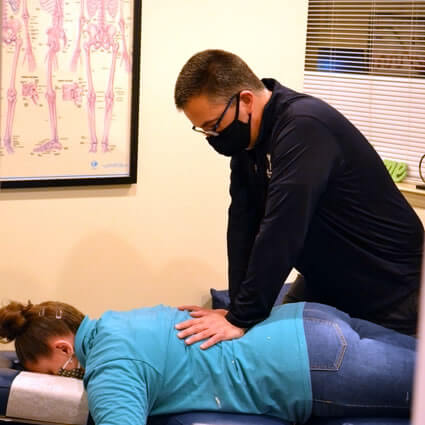 Dr Mark adjusting a patient's lower back