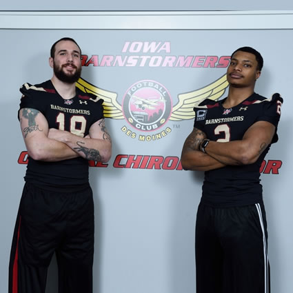 Barnstormers athletes by logo on wall