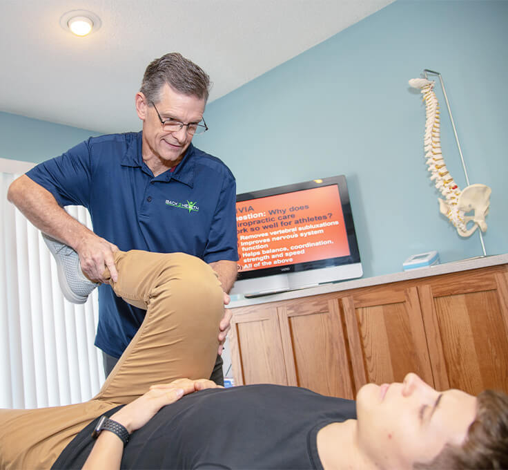 Chiropractor massaging patient
