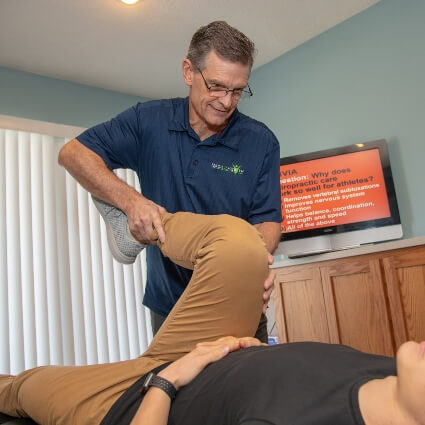 doctor adjusting persons leg