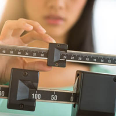 Woman checking weight on scale