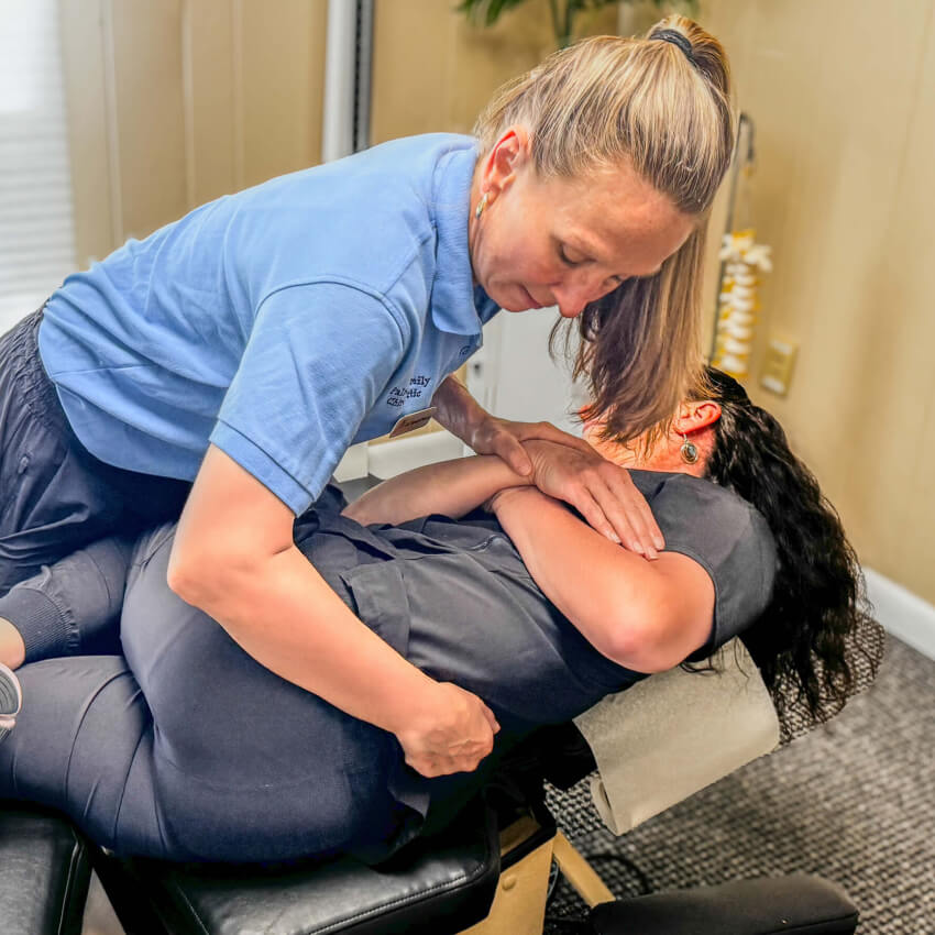 Milford chiropractor Dr Palmer adjusting patients back
