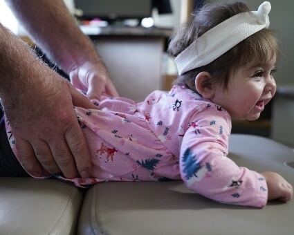 Pediatric Chiropractic Chiropractor adjusting girl's lower-back