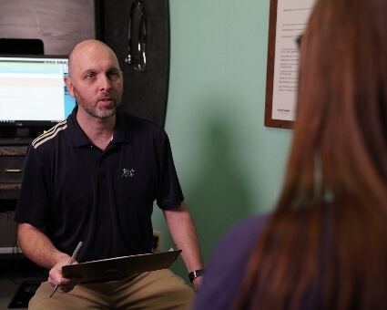 Chiropractor discussing paperwork with patient