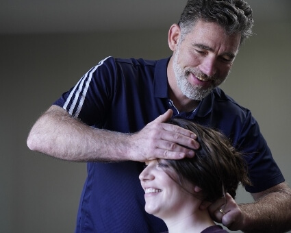 Chiropractor adjusting patient's neck