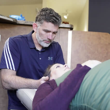 Dr. Blau adjusting pregnant woman