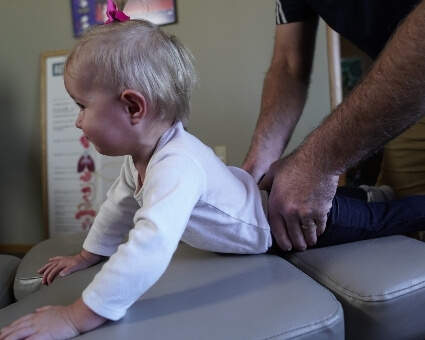 Pediatric Chiropractic Chiropractor adjusting pediatric patient's back