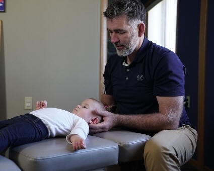 Pediatric Chiropractic Young boy receiving neck adjustment