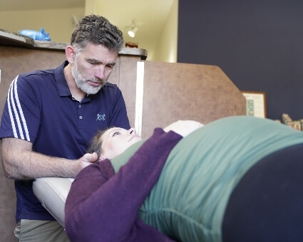 Portage chiropractor adjusting a pregnant woman