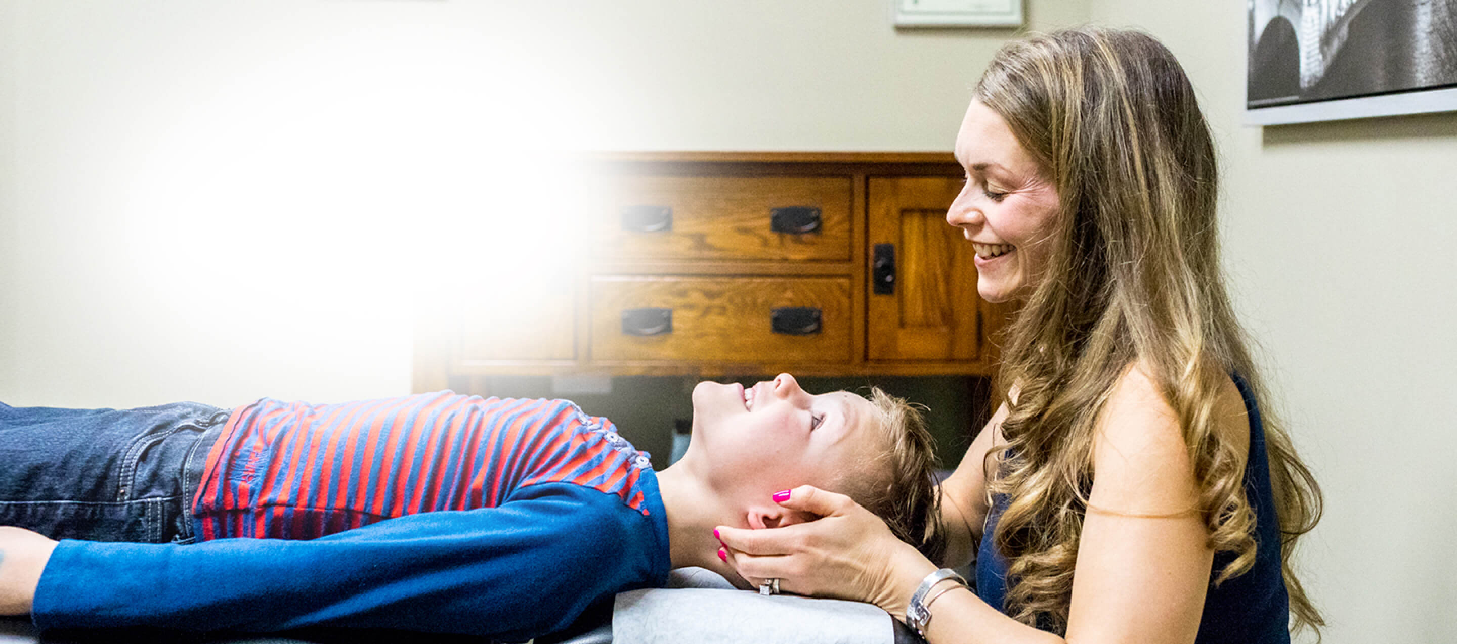 Dr. Sarah with hands on boys face