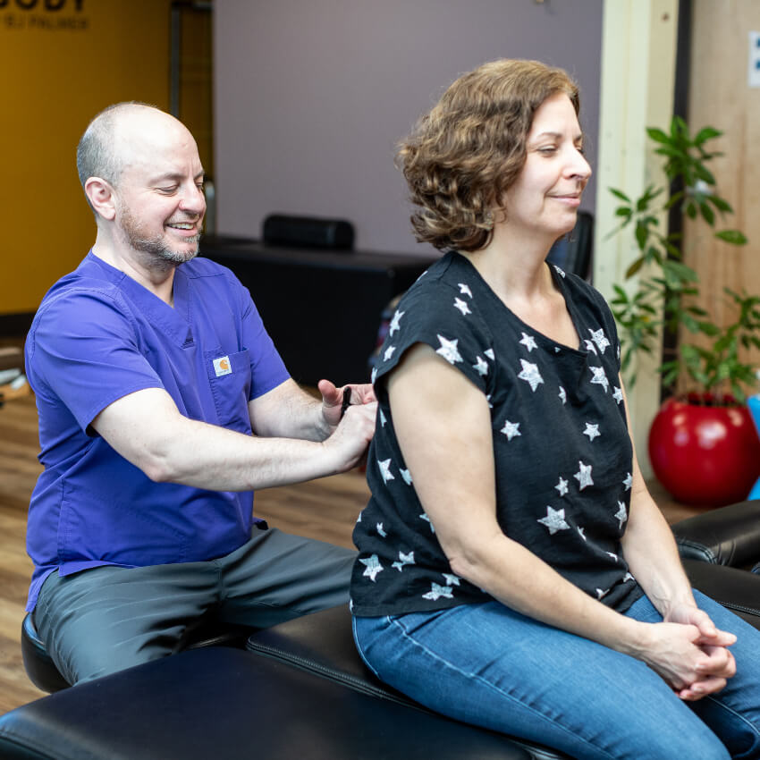 Portland chiropractor adjusting patients back