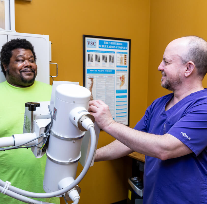 Chiropractor checking patient