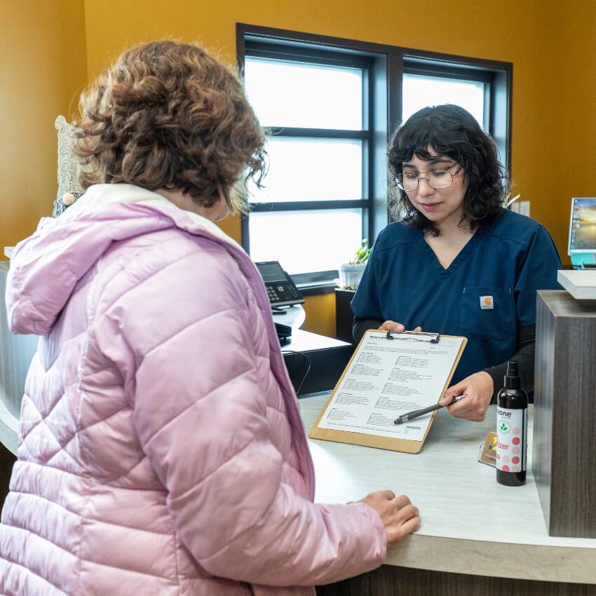 patient at our front desk doing paperwork