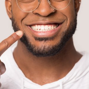 man pointing to his smile