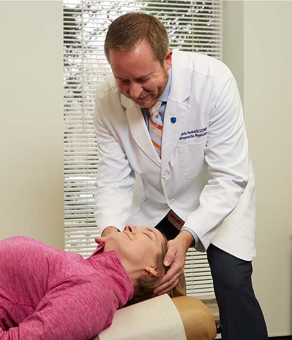 Doctor adjusting womans neck