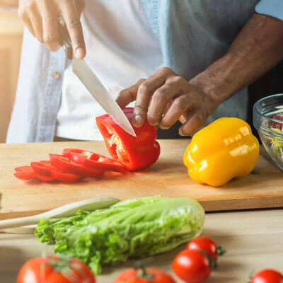 person cutting bell peppers