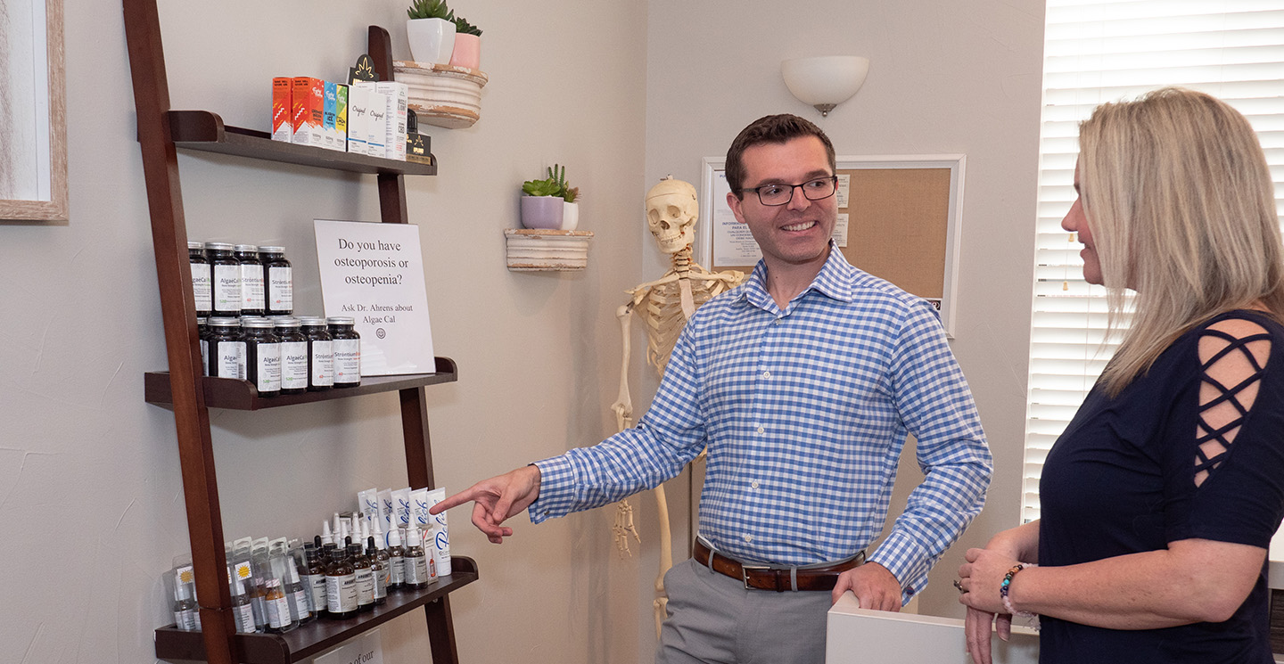 Dr. Campbell pointing to supplements