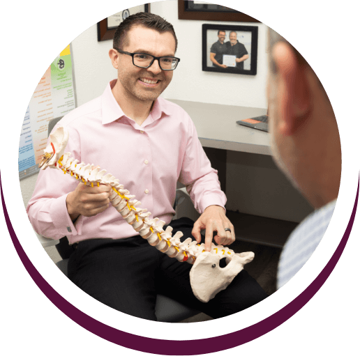 Chiropractor showing patient spine model