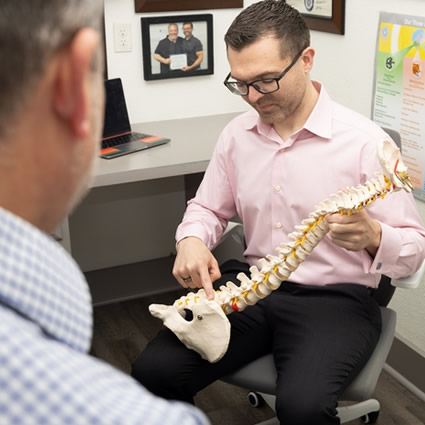 Chiropractor discussing spine health with a patient