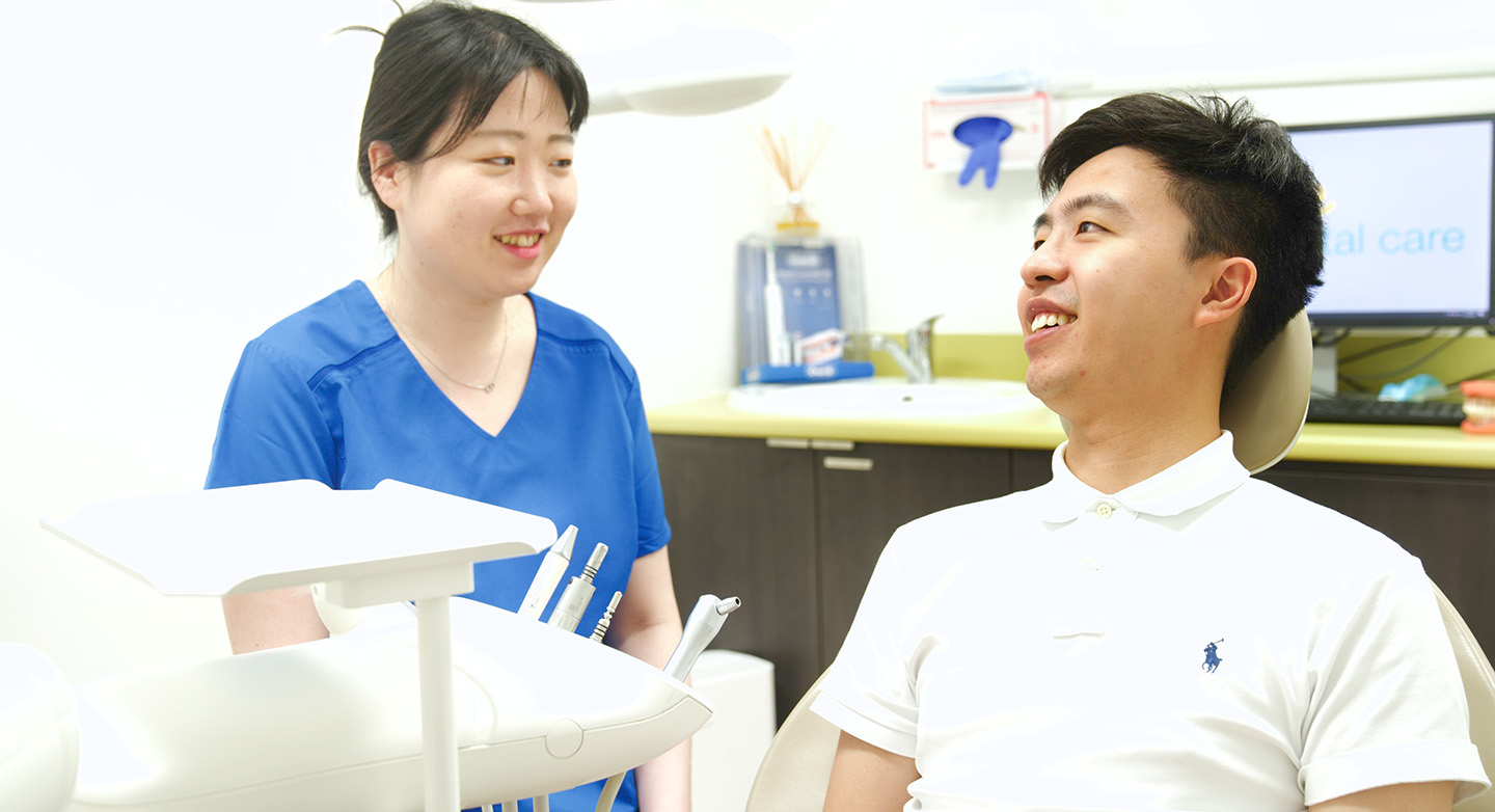  Dr Min Jae Kim with patient in dental chair