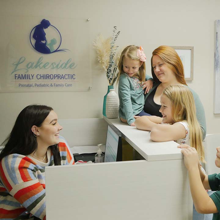 Mother with children at reception desk