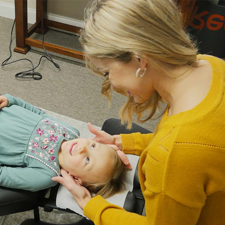 Dr. Nicole adjusting young girl