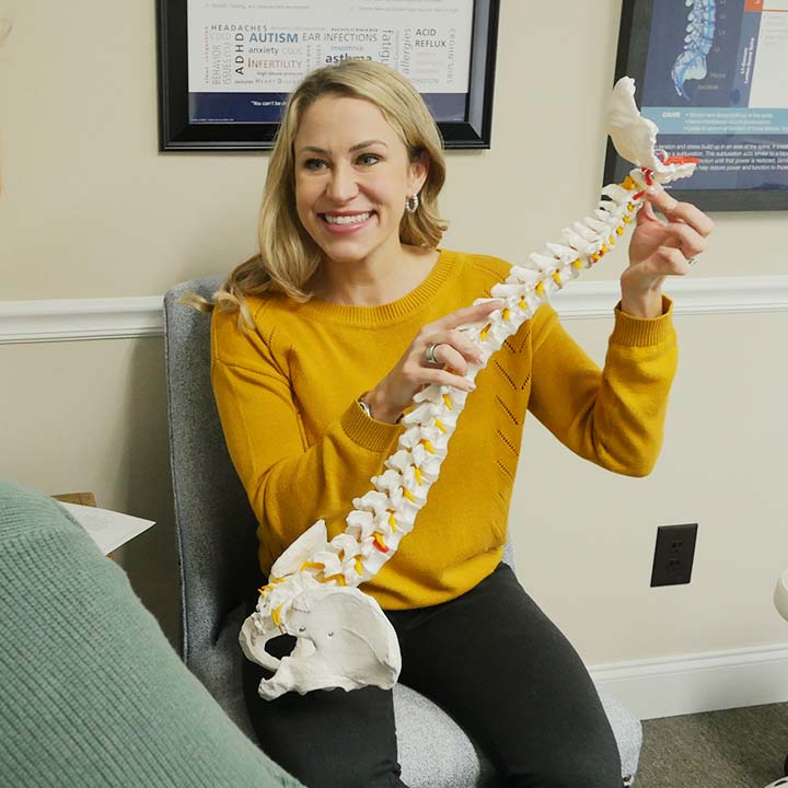 Dr. Miller holding spine model