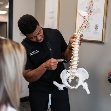 Dr Jagerran explaining spine care to patient