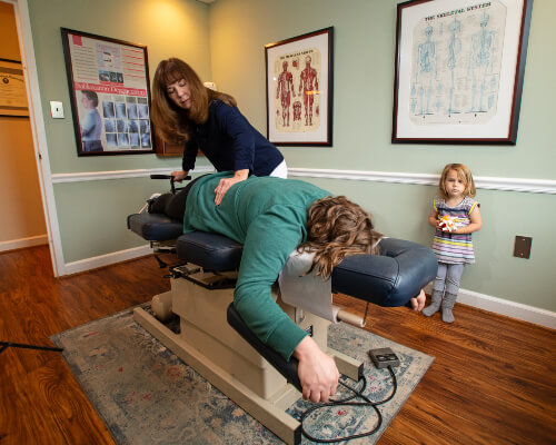 Adjusting woman on table
