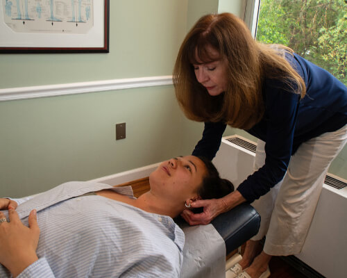 Adjusting woman's neck