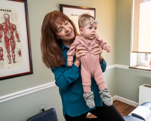 Alexandria Chiropractor Dr. Catherine holding baby